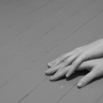 Hands on painted wood floor.