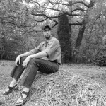 Sitting on a pile of mulch.