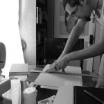 Cutting card stock covers for notebooks.
