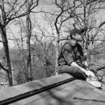 Sitting on the roof.