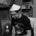 Birthday Boy with party hat and cupcake.