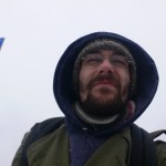 The snow stings my face.